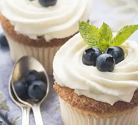 Cupcakes mit Buttercreme Topping im Swirl Look und Blaubeeren- Minz Deko.