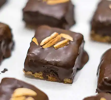 Quadratische Plätzchen mit Mandelgarnitur.